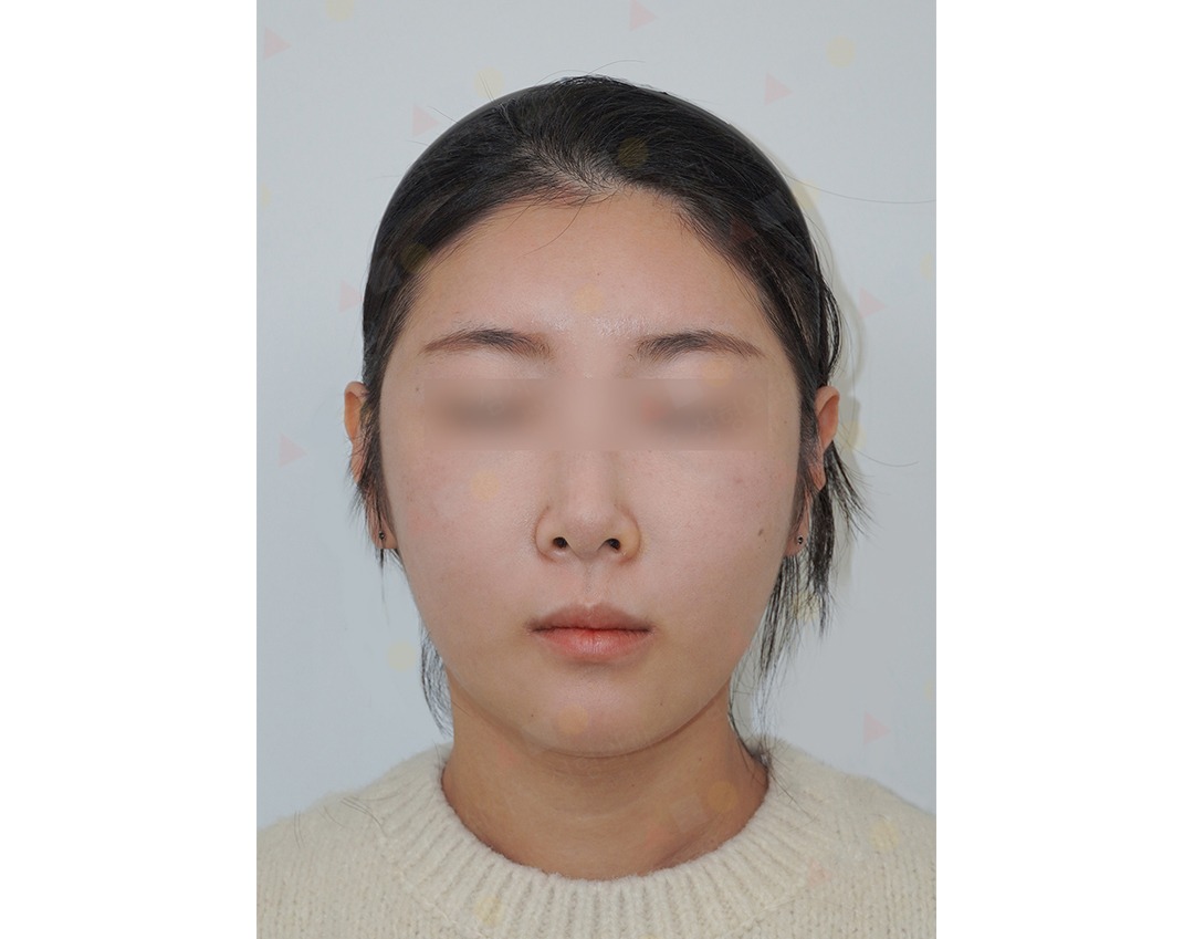 Person with closed eyes wearing a cream sweater.