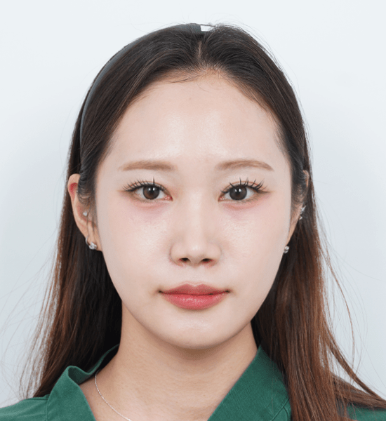 Person smiling with long hair and green top.