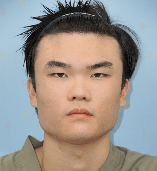 Person with spiky hair and neutral expression